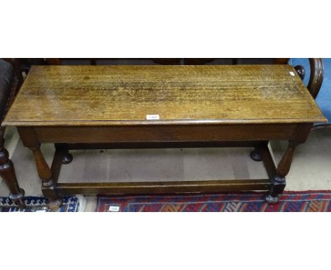 A 1920s oak stool on baluster legs, L98cm 