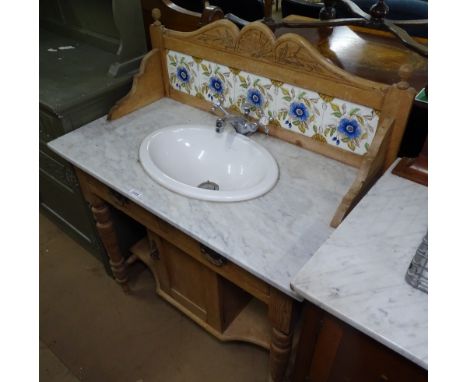 An Art Nouveau washstand with raised tiled back and marble top, inset Villeroy &amp; Boch sink with chrome taps, drawers and 