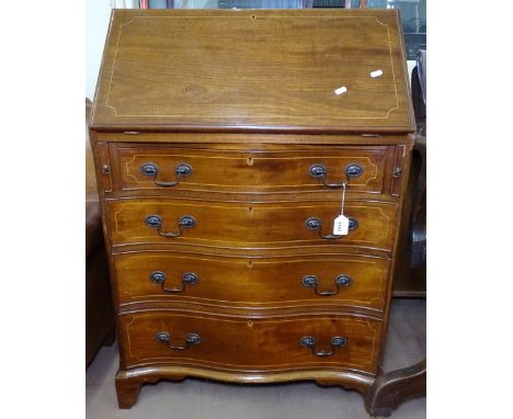 An Edwardian mahogany bureau, with fitted interior above 4 long serpentine-front drawers on bracket feet 