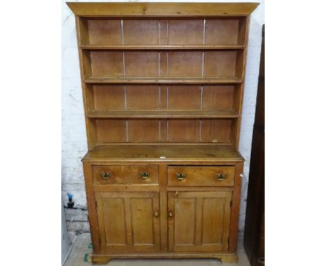 A Victorian pine dresser, with open plate rack above drawers and cupboards, on bracket feet, W117cm, H196cm, D39cm 