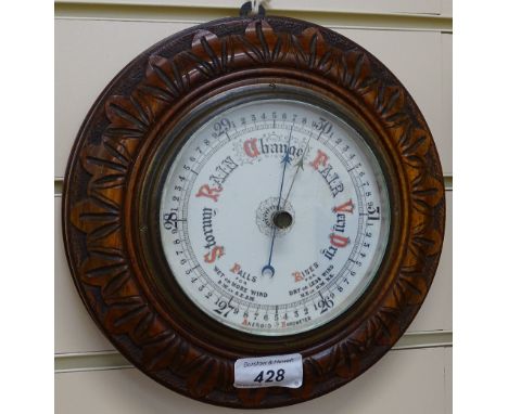 An aneroid barometer set in carved mahogany frame, diameter 8.5" 