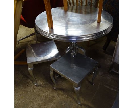 A brushed aluminium circular table on tripod base, and a pair of matching stools 