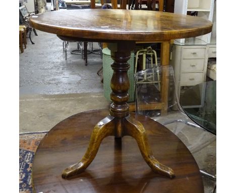 An oak tilt-top table on tripod base, W76cm 