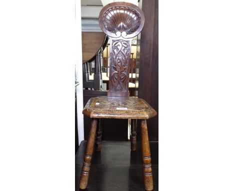 An Antique carved oak spinning stool 
