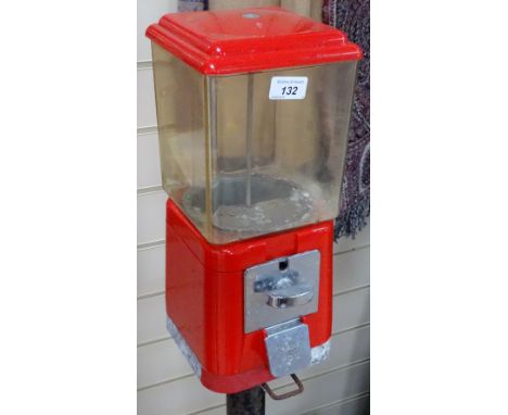 A Vintage red plastic bubblegum dispensing machine, on cast-iron stand, height 54.5" 