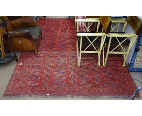 A large red ground Turkoman Tekke carpet, with symmetrical pattern, 270cm x 200cm 