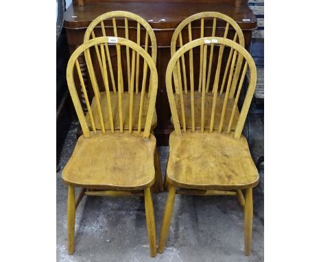 A set of 4 elm-seated Ercol stick-back chairs 