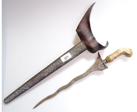 An Eastern kris with carved wood handle in embossed metal scabbard, 19.5" 
