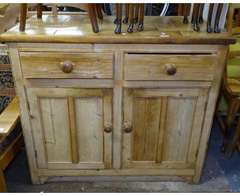 A pine and tile-top kitchen dresser base with fitted drawers and cupboards, W107cm 