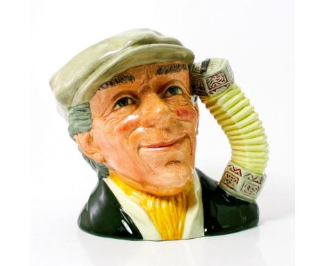 Grey cap, green coat, yellow scarf.From its roots with the early wandering minstrels, entertaining in public places for money