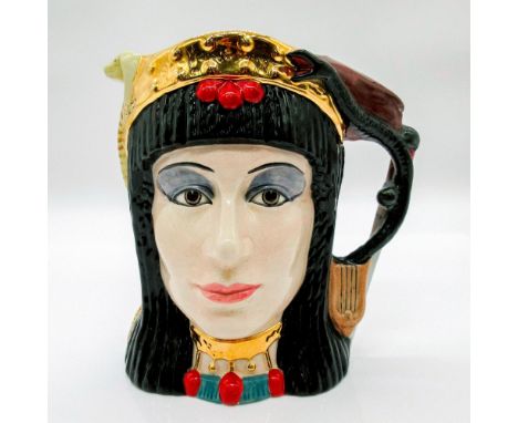 Glazed, hand painted ceramic. Two-faced jug. One side is Cleopatra with an asp and harp handle. The other side is Antony with