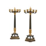 A PAIR OF FRENCH EMPIRE PATINATED AND GILT BRONZE CANDELABRA, AFTER THE ANTIQUE
