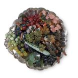 A GROUP OF HARDSTONE BUNCHES OF GRAPES AND FRUITS WITH A SILVER-PLATED SHELL SHAPED DISH