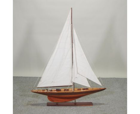 A French wooden model of a pond yacht, with sails and rigging, on a wooden stand, 125cm high