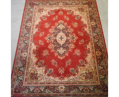 A large carpet, on a red ground, 328 x 250cm