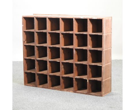 A pine wall shelf, containing an arrangement of pigeon holes, 102cm