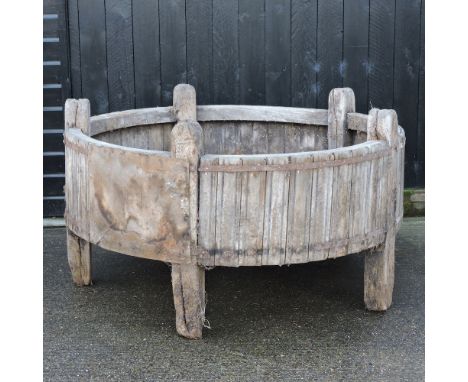 A large circular wooden and iron bound feeding trough, 154 cm diameter