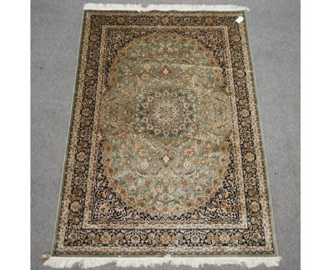 A Keshan style carpet, with floral design on a green ground, 230 x 160cm 