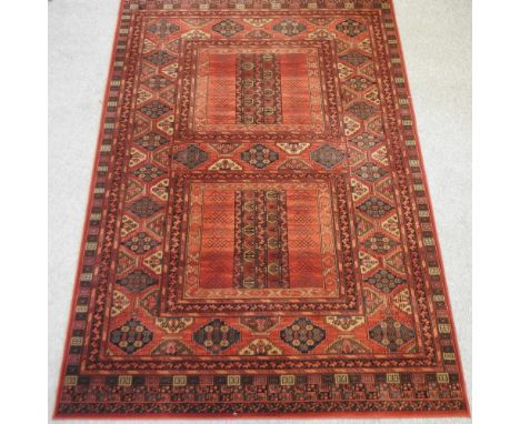 A large woollen carpet on a red ground, 300 x 202cm