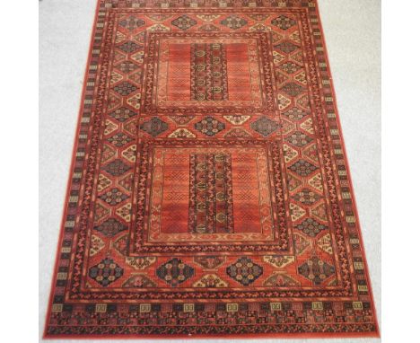 A large woollen carpet on a red ground, 300 x 202cm