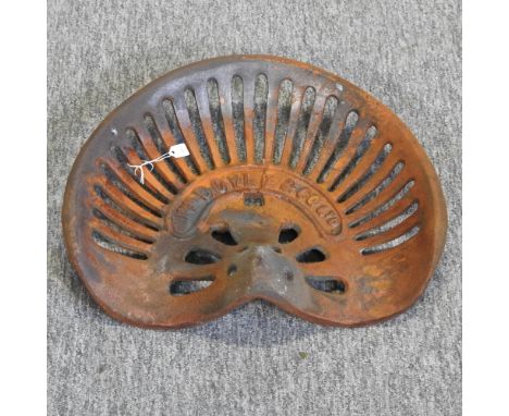 A rusted metal tractor seat 