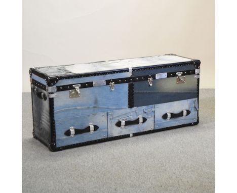 A denim upholstered trunk, with a hinged lid, 133cm