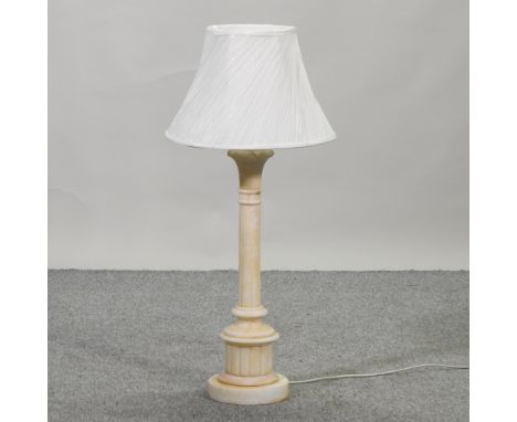 A large carved white alabaster table lamp and shade, 92cm high