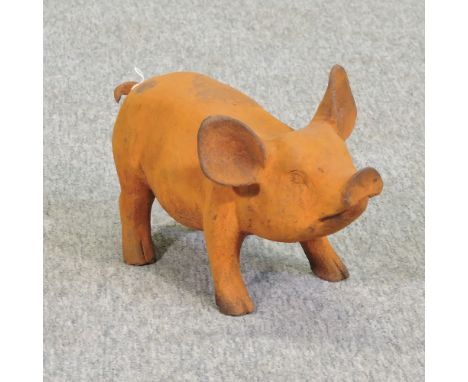 A rusted cast iron model of a pig, 37cm