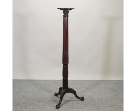 An early 20th century carved mahogany torchere, on a tripod base, 153cm high