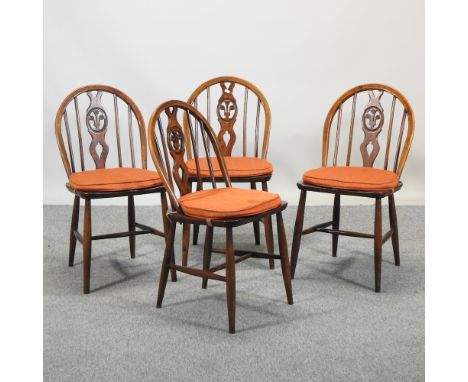 A set of four Ercol elm dining chairs