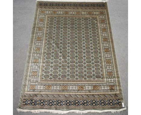 A Bokhara style carpet, with geometric design on green ground, 280 x 200cm