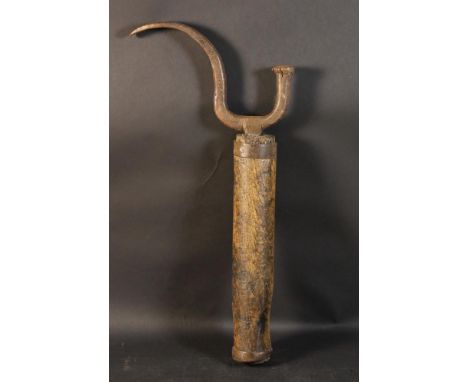 An 18th Century Cobbler's 'Handy' with a S-scroll iron fork driven into an ash post bound in iron straps, 26 ins (66 cms) in 