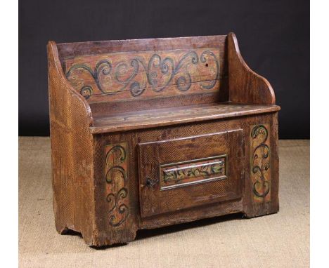 An 18th Century Swiss Painted Pine Folk Art Bench. The box form seat decorated with naively painted panels of scrolling folia