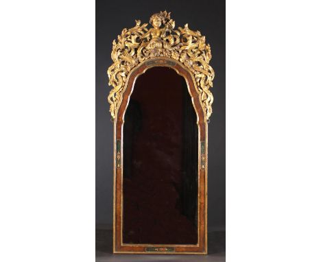 A Late 18th Century Arch-topped Mirror. The moulded walnut frame having gilded edging and floral painted rebates, surmounted 