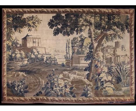 A 17th Century Aubusson Tapestry depicting hunting dogs leaping through a park landscape in pursuit of a hare, with grand bui