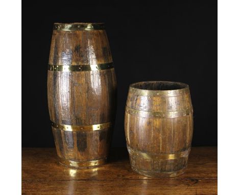 Two Coopered Oak Stick Stands bound in studded brass straps, one 25 ins (64 cms) in height, the other 14 ins (36 cms).