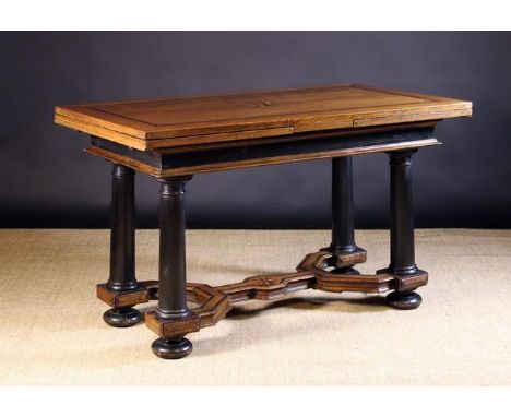 A 17th Century Dutch Oak Draw-leaf Table.  The rectangular top inlaid with ebony banding above ebonised frieze rails edged in