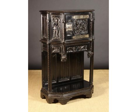 A 19th Century Carved & Ebonised Dressoir in the Gothic style.  The canted cupboard carved with figural panels above a frieze