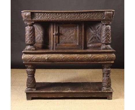 A 17th Century Style Oak Court Cupboard.  The canted cupboard carved with quatrefoil designs and flanked by turned posts with