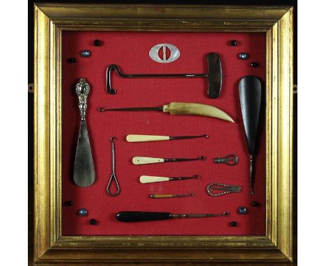 A Collection of Antique Button Hooks and Shoe Horns, presented in a glazed case. 
