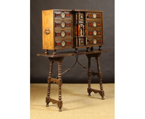 A 17th Century Spanish Collector's Cabinet on associated Stand. The cabinet having a break-front centre section enclosing fiv