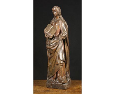 A 15th Century Oak Sculpture of Madonna, Circa 1480. The hollow backed carving depicted holding an open book, with her long w