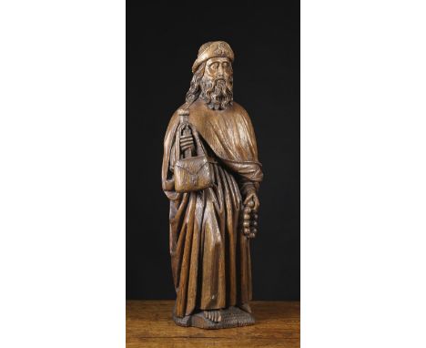 A 15th Century Oak Carving of St James of Compostela. The bearded saint depicted wearing a hat emblazoned with a scallop shel