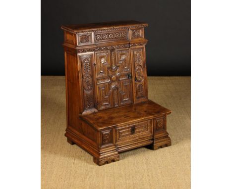 An Italian Carved Walnut Prie-Dieux Cabinet, Circa 1700, with a frieze drawer to the top above a cupboard and box-form kneele
