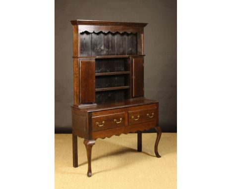 A Small 19th Century Oak Dresser.  The rack having stained pine planked back with a moulded cornice above a serpentine edged 