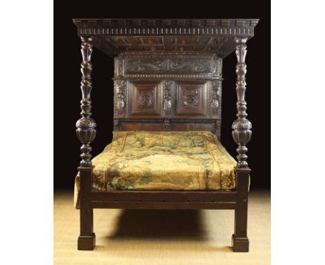 A 17th Century & Later Carved Oak Full Tester Bed. The canopy having a dentil moulded cornice with nulled rails framing twelv
