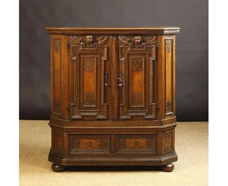 A 17th/Early 18th Century Continental Cupboard. The two front doors on engraved strap hinges having decorative break-sided pa