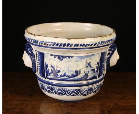 A Blue & White Tin Glazed Planter decorated with scenic panels and having moulded face masks either side, 8¾ ins (22 cms) in 