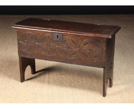 A Charming 18th Century Boarded Oak Child's Coffer. The lid having a moulded edge and iron split pin hinges. The front board 