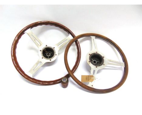 TWO WOOD RIMMED STEERING WHEELS with aluminium centres, approximately 39.5cm and 38cm diameter respectively; together with a 